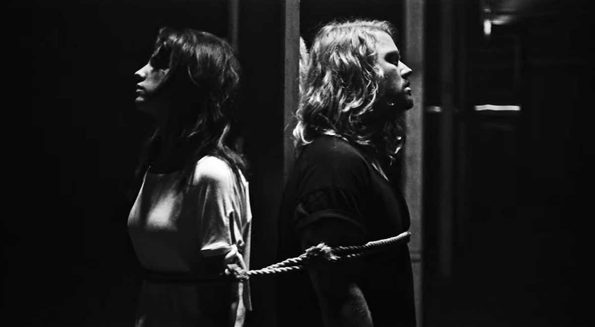 See Underoath Singers Bound and Stabbed in Creepy New “Bloodlust” Video