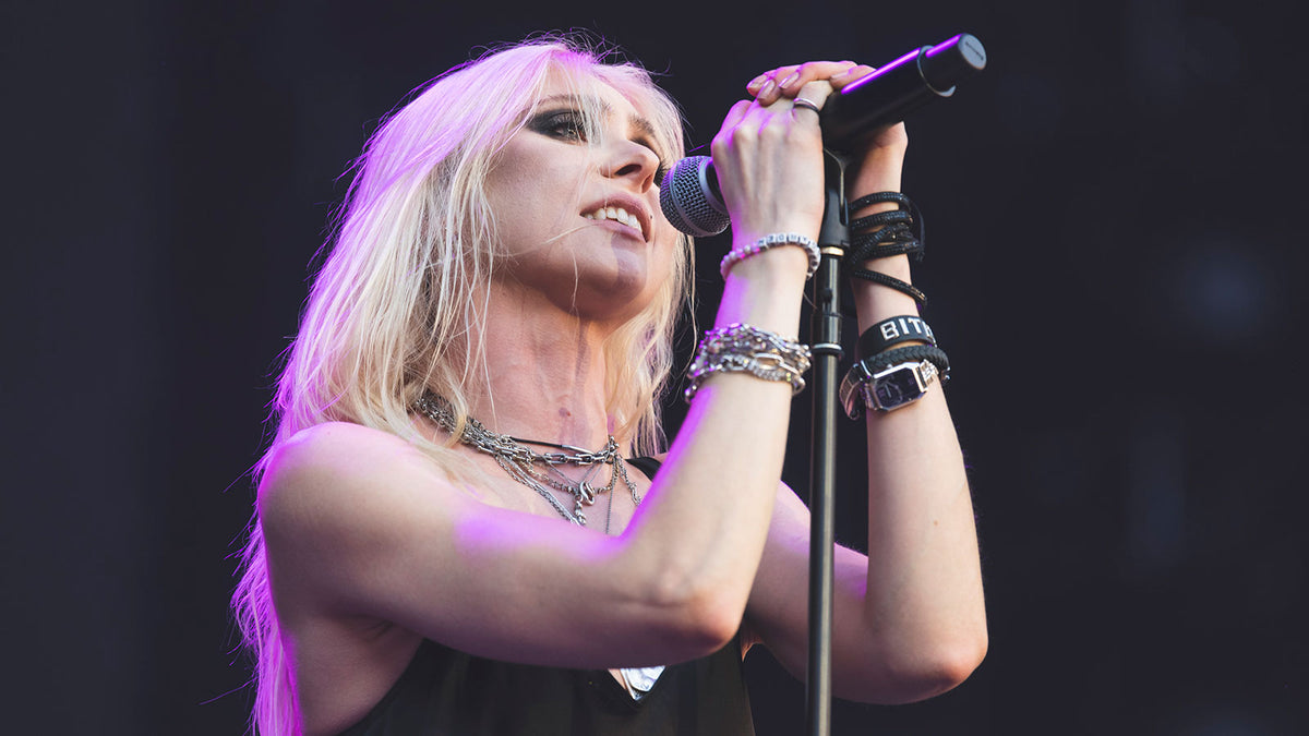 THE PRETTY RECKLESS’ TAYLOR MOMSEN bit by bat onstage opening for AC/DC