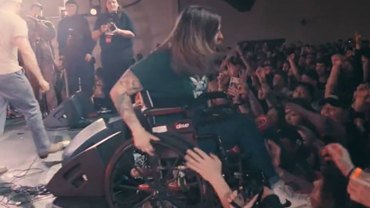 See KUBLAI KHAN fan make epic stage dive in wheelchair